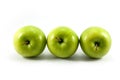 Three green apples arranged horizontally isolated on a white background. Royalty Free Stock Photo