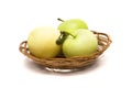 Three green apples in a basket on a white background Royalty Free Stock Photo