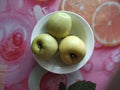 Three green apples in a plate Royalty Free Stock Photo