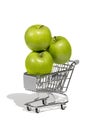 Three green apples in a supermarket trolley Royalty Free Stock Photo