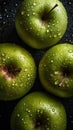 three green apples with water droplets on them on a black surface with drops of water on the surface and on top of the apples are Royalty Free Stock Photo