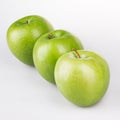 Three green apples on the white