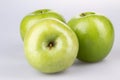 Three green apples on white background