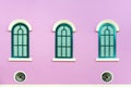 Three green arched windows on pink wall Royalty Free Stock Photo