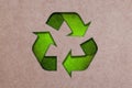 The three green arrows going in a triangle, international recycle symbol on Brown Cardboard. Paper or cardboard eco friendly Royalty Free Stock Photo