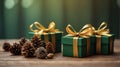 Three green boxes with gold ribbons on top of a wooden table with pine cones. Royalty Free Stock Photo