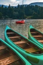 Three green canoes and red dinghy at Lake Bohinj Royalty Free Stock Photo