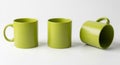 Three Green Ceramic Mugs on a White Background pottery drinkware Royalty Free Stock Photo