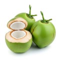 Three green coconuts with one cut open to show the white interior Royalty Free Stock Photo