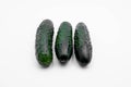 Three green cucumbers on a white background Royalty Free Stock Photo