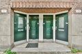 three green doors on the side of a building Royalty Free Stock Photo