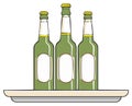 Three Green Glass Bottles with Blank White Labels on a Tray Beverages and Refreshments Royalty Free Stock Photo