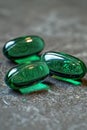 Three green glass objects sitting on a table with one of them broken, AI