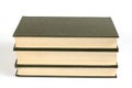 Three Green hardcover books on a white background. Stack of clos