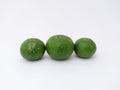 three green kaffir limes in landscape mode on a white background Royalty Free Stock Photo