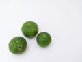 three green kaffir limes in landscape mode on a white background Royalty Free Stock Photo