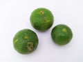 three green kaffir limes in landscape mode on a white background Royalty Free Stock Photo