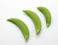 Three green peas on a white background to be used as part of any graphic design