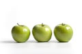 Three green shiny Granny Smith apples Royalty Free Stock Photo