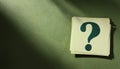 Paper notes with question marks on Khaki background, flat lay. Space for text Royalty Free Stock Photo
