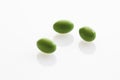 Three green tablets on white background