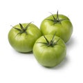 Three green unripe tomatoes