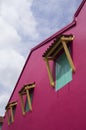 Three green windows on a pink wall. Royalty Free Stock Photo