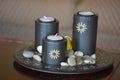 three grey ornamentals candles on display.