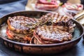 Three grilled beef tenderloin steaks coated bacon on a frying pa Royalty Free Stock Photo