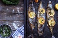 Three grilled fish, on black baking tray, with copy space Royalty Free Stock Photo