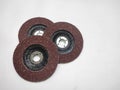 Three (grinding wheels) abrasive flap discs arranged on a white surface Royalty Free Stock Photo
