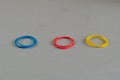 Three groups of stationery rubber bands on a gray background. Mu