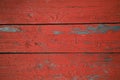 Three grunge wooden boards with weathered, peeling red paint. Vintage backdrop