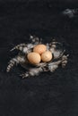 Three guinea fowl eggs in metal bowl.