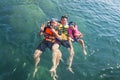 Three guys floating happily in the sea Royalty Free Stock Photo