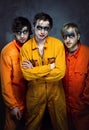 Three guys in orange uniforms Royalty Free Stock Photo