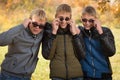 Three guys in sunglasses in autumn park