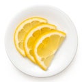 Three half slices of fresh lemon on white plate from above