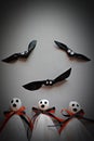 Three halloween ghosts and three bats on gray background Royalty Free Stock Photo