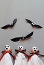 Three halloween ghosts and three bats on gray background Royalty Free Stock Photo