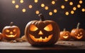 Three Halloween pumpkins on table, carved into jackolanterns Royalty Free Stock Photo