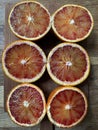 Three Halved Blood Oranges Ready For Juicing