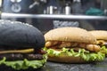 Three hamburger with beef meat burger and fresh vegetables on dark background. Tasty food.