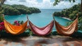 Three hammocks overlooking the ocean surrounded by lush greenery on a bright sunny day Royalty Free Stock Photo
