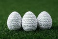 Three hand painted easter eggs resting on vibrant green grass Royalty Free Stock Photo