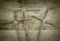 Three handmade crosses lashed together with twine on a rustic wooden background