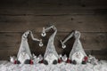 Three handmade gimps on wooden background for christmas decorati