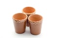 Three handmade glasses of clay with pattern.