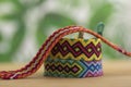 Three handmade homemade colorful natural woven bracelets of friendship isolated on light wooden background Royalty Free Stock Photo