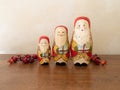 Three Handpainted Wooden Santa Claus Dolls with Red Berries